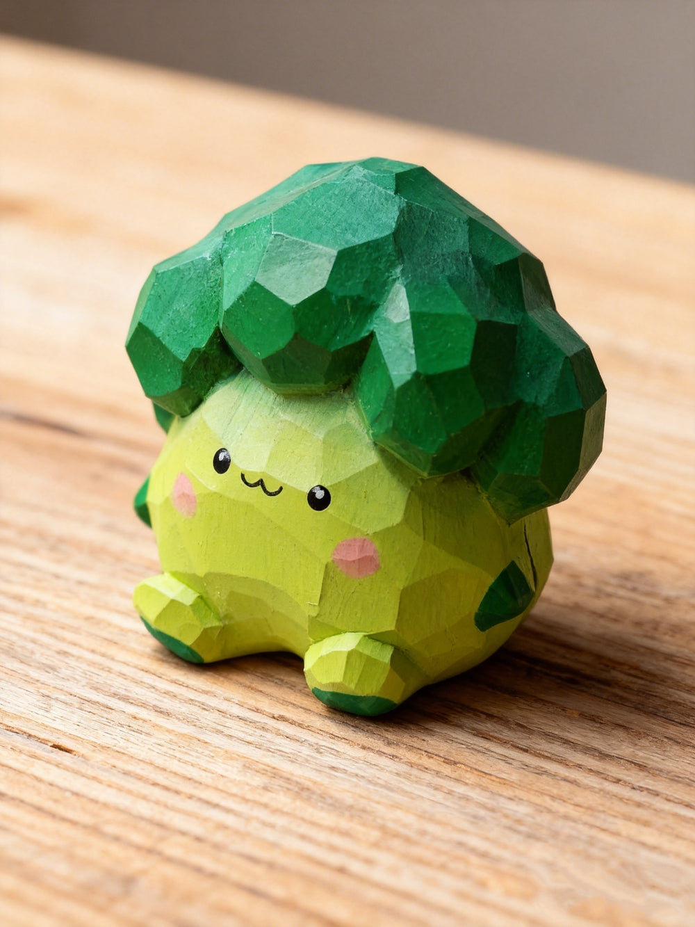 Handcrafted low-poly wooden broccoli figurine with a cute kawaii face and pink cheeks, sitting on a wooden table by a sunny window by PINEAURA