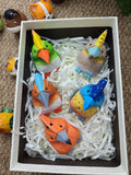Five hand-carved and hand-painted wooden hoopoe birds in vibrant colors including green, orange, and blue, nestled in a gift box.