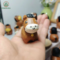 Handcrafted low-poly brown horse figurine with black mane, hand-carved and hand-painted, held in hand by PINEAURA