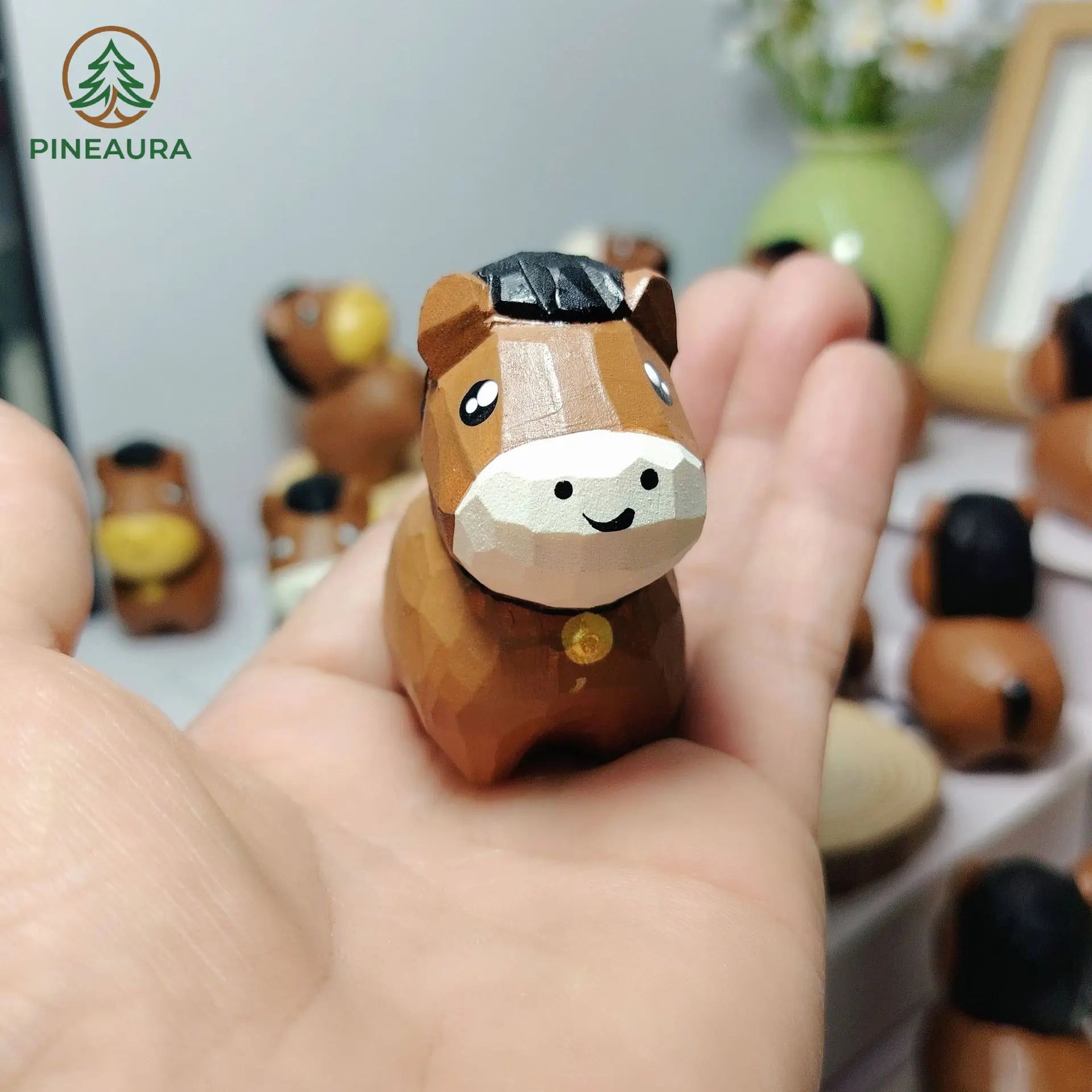 Handcrafted low-poly brown horse figurine with black mane, hand-carved and hand-painted, held in hand by PINEAURA