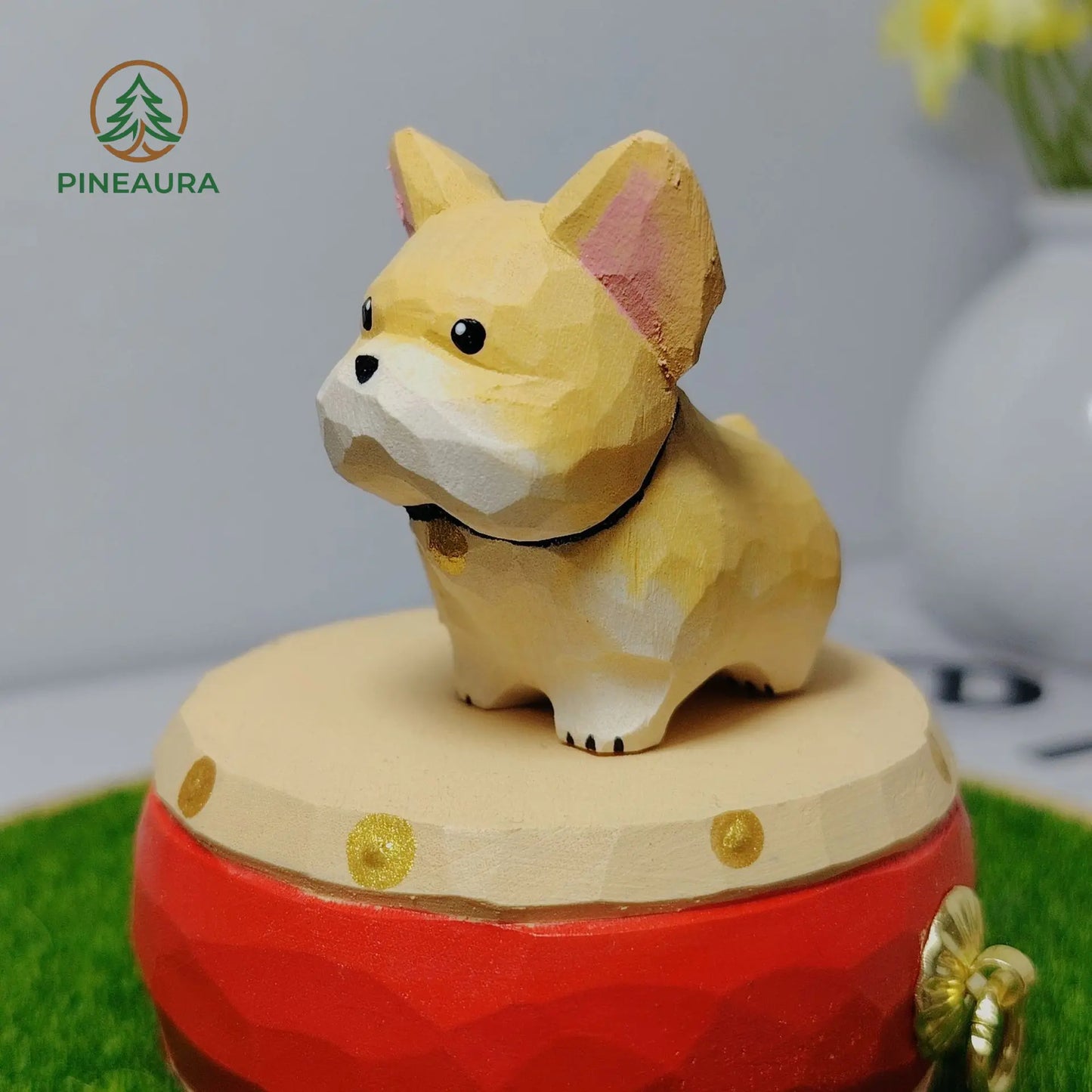 Adorable low-poly yellow French Bulldog figurine with black collar, standing on a red music box by PINEAURA